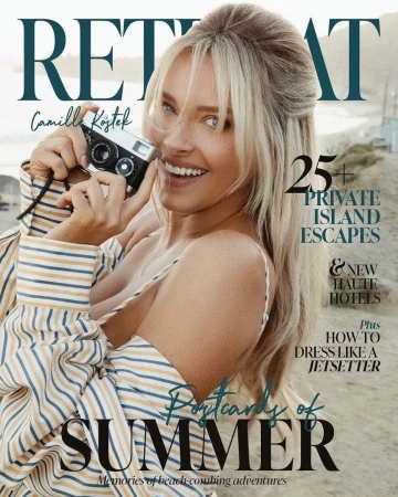 Magazine cover featuring smiling blonde woman holding vintage camera on beach, with 'Retreat' title and travel-themed text overlays.