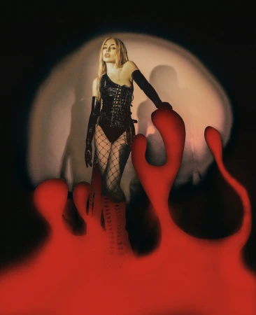 A woman with long blonde hair poses in black outfit with fishnet stockings, thigh-high boots, and long gloves, studio lighting.