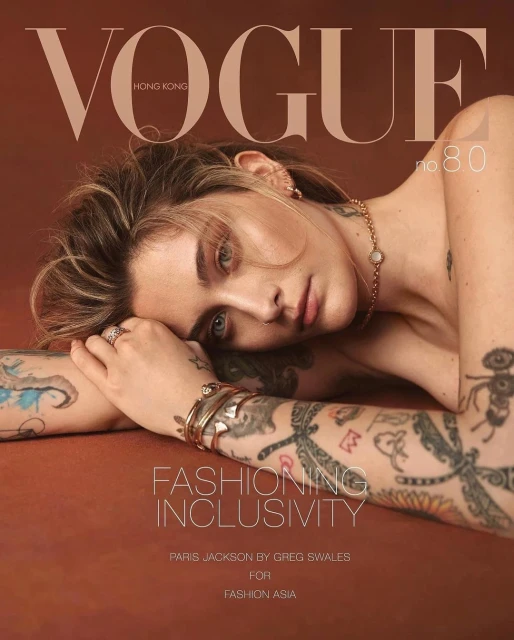 Vogue Hong Kong cover featuring Paris Jackson with tattoos, jewelry, and a caramel backdrop, photographed by Greg Swales for Fashion Asia.