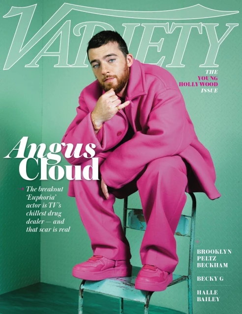 Magazine cover of Angus Cloud in a pink suit sitting on a chair against a mint green background with 'Variety' printed at the top.