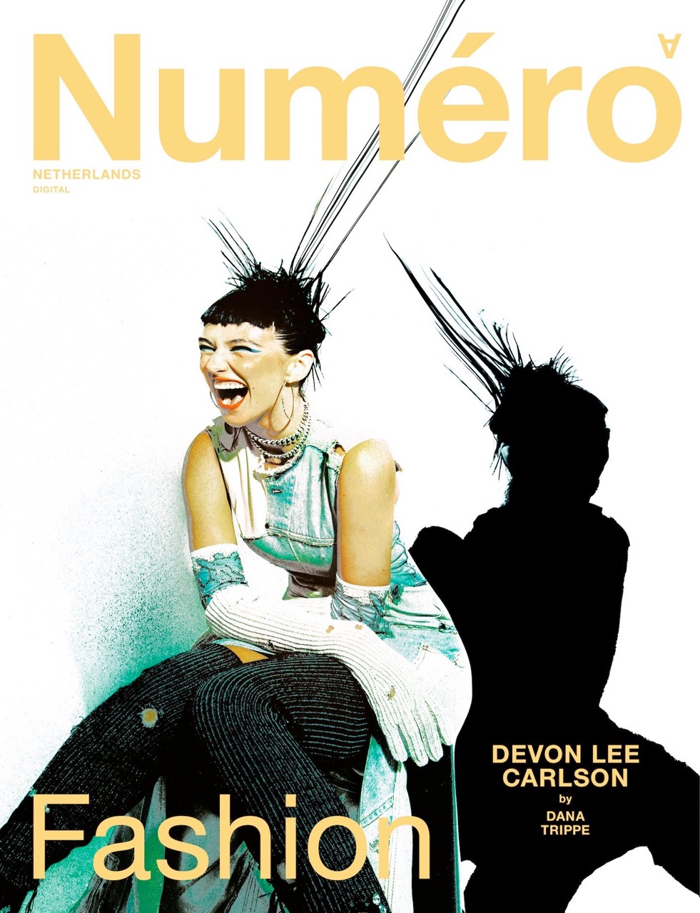 Fashion magazine cover features a smiling model with an updo and edgy style, next to a shadow, promoting the magazine's fashion content.