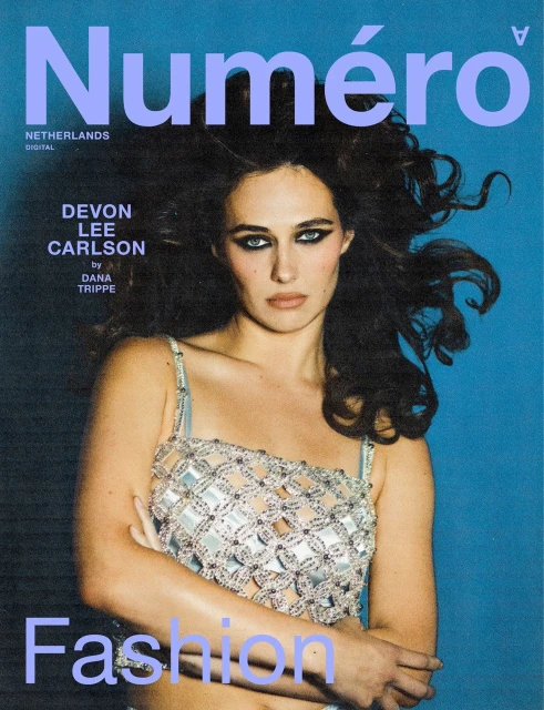 Magazine cover featuring Devon Lee Carlson wearing a silver top against a blue background with 'Numero Netherlands Digital' text.