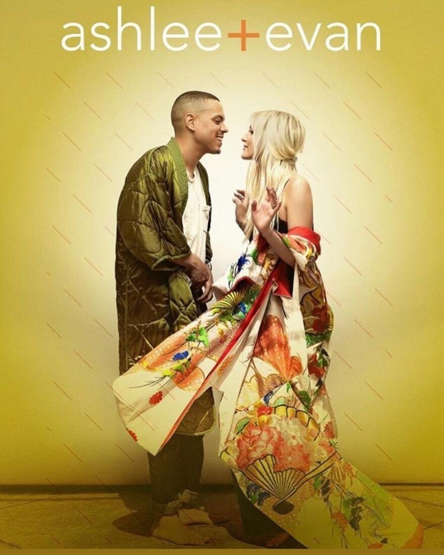 A stylish photo features a man and a woman looking at each other. The woman wears a floral kimono, and the man wears a padded jacket.