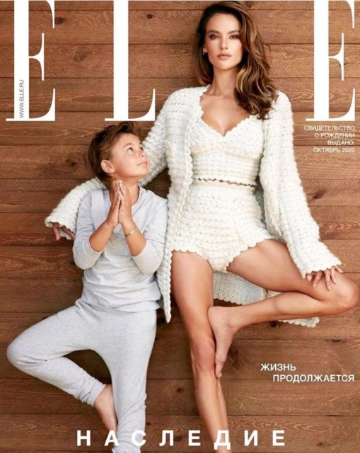 Alessandra Ambrosio and child pose for ELLE magazine cover, both barefoot in casual outfits against wood background.