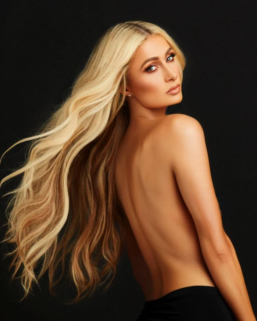 Blonde woman with long, wavy hair poses with bare shoulders against a dark background in a portrait shot.