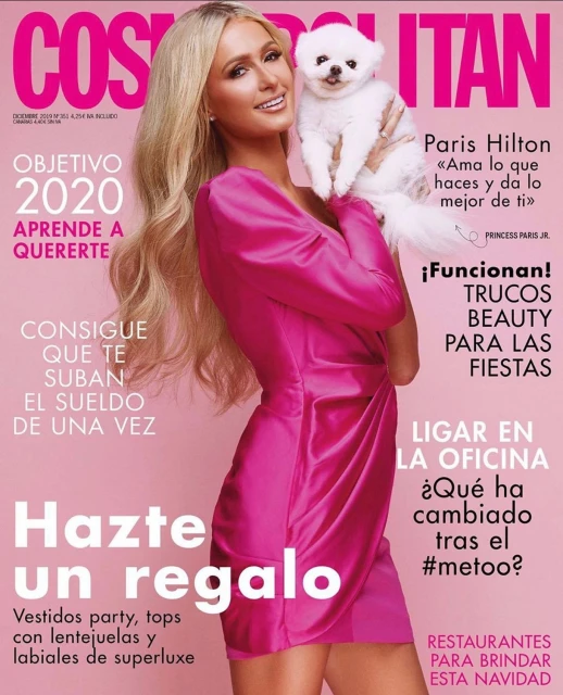 Magazine cover featuring Paris Hilton in a pink dress holding a white dog, showcasing beauty and fashion elements.