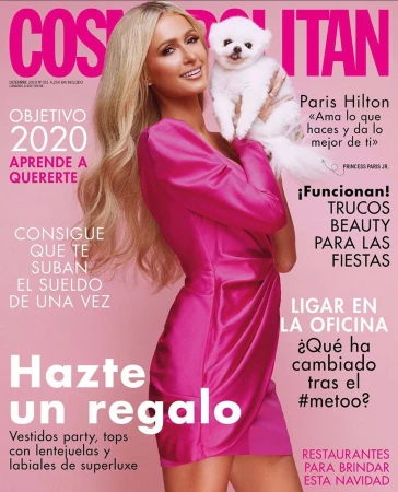 Magazine cover featuring Paris Hilton in a pink dress holding a white dog, showcasing beauty and fashion elements.