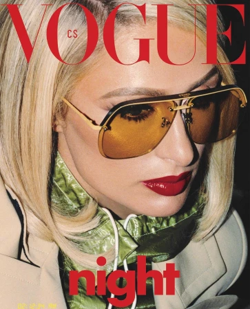 Vogue cover featuring a close-up of a blonde woman wearing gold aviator sunglasses, red lipstick, and a tan jacket over a green top.