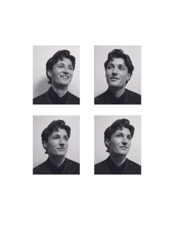Four black and white portrait frames of a man with styled hair wearing a dark patterned top against a white wall.