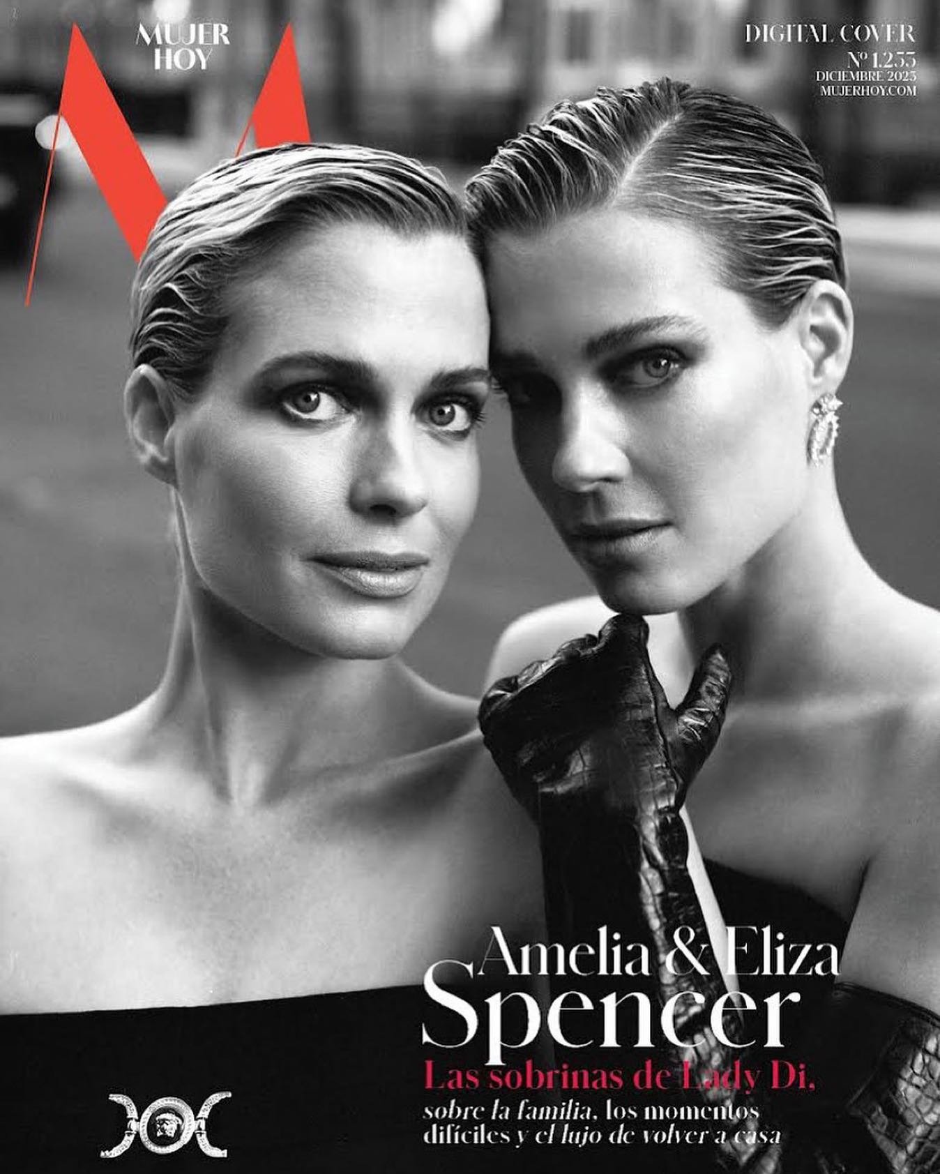 Black-and-white magazine cover featuring a close-up of two adult women with slicked-back hair, dark evening wear, and gloves against an outdoor background.