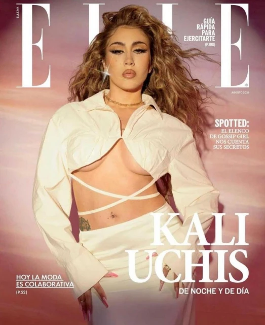 Elle magazine cover featuring Kali Uchis. Uchis wears a white crop top and skirt. The image has a soft, diffused light and a warm color grade.
