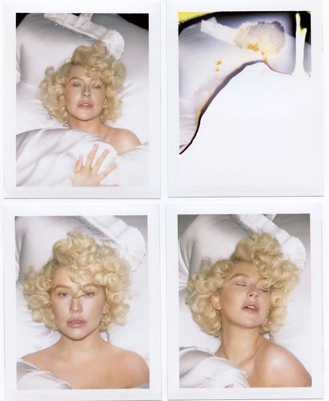 Four polaroid-style photos feature Christina Aguilera in bed with blonde curls, covered by white sheets against a dark backdrop.