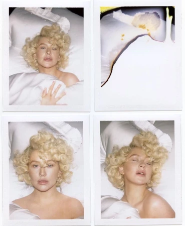 Four polaroid-style photos feature Christina Aguilera in bed with blonde curls, covered by white sheets against a dark backdrop.