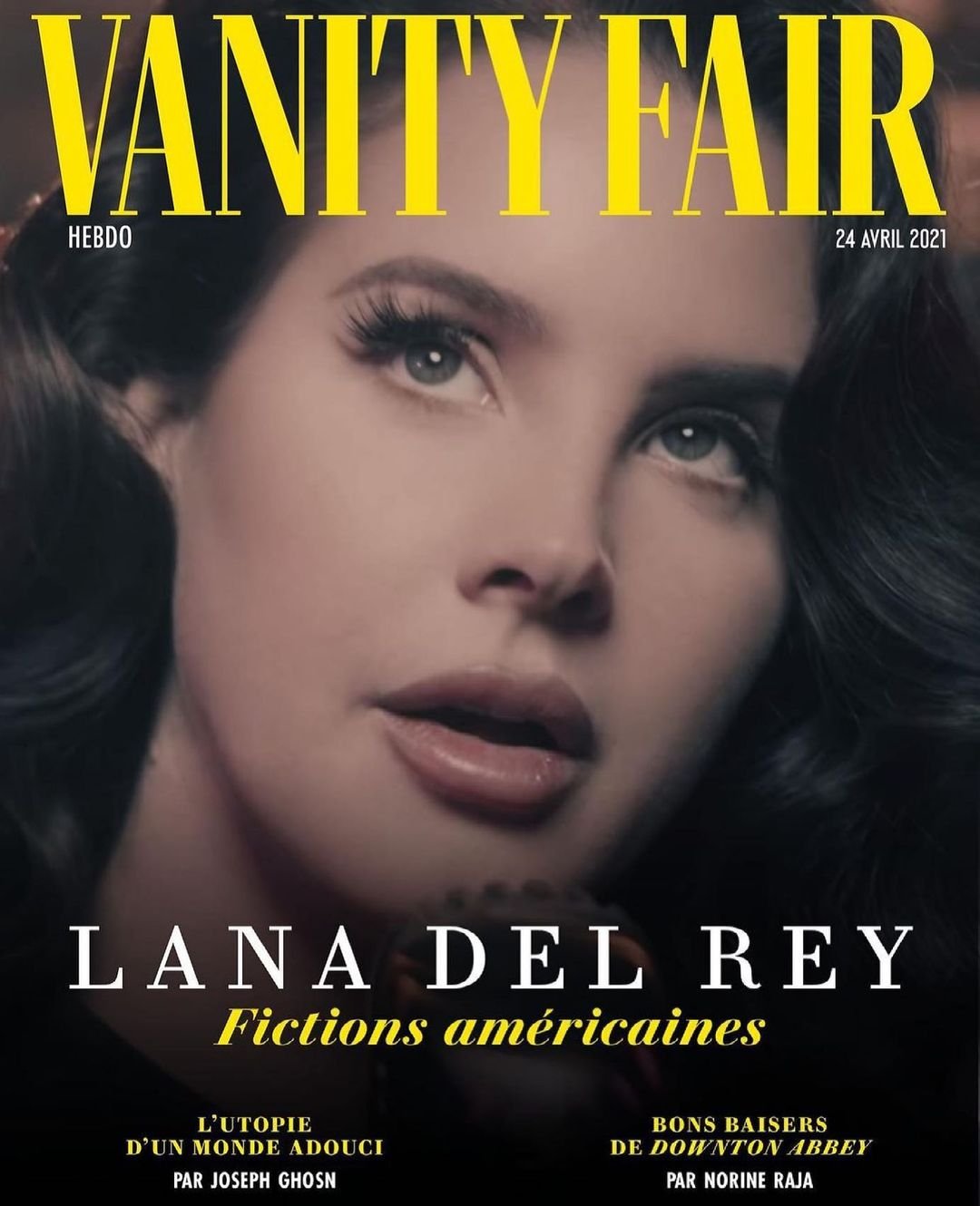Vanity Fair cover featuring Lana Del Rey looking up, soft lighting, with magazine text: title, date, and names of writers.