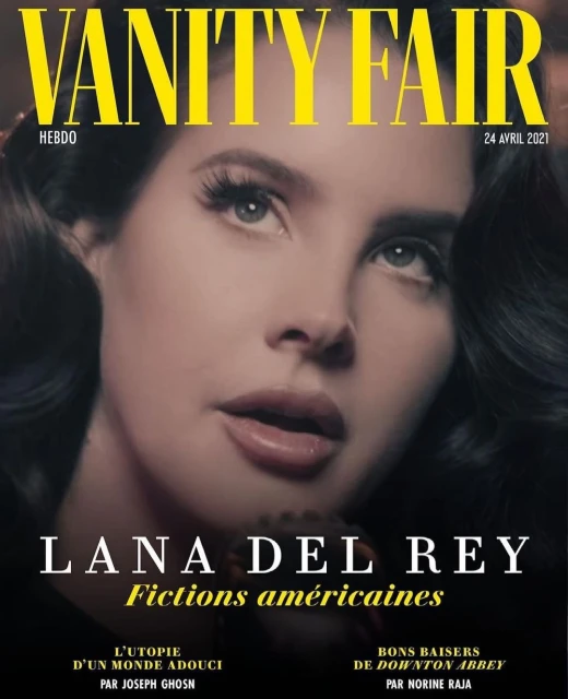 Vanity Fair cover featuring Lana Del Rey looking up, soft lighting, with magazine text: title, date, and names of writers.