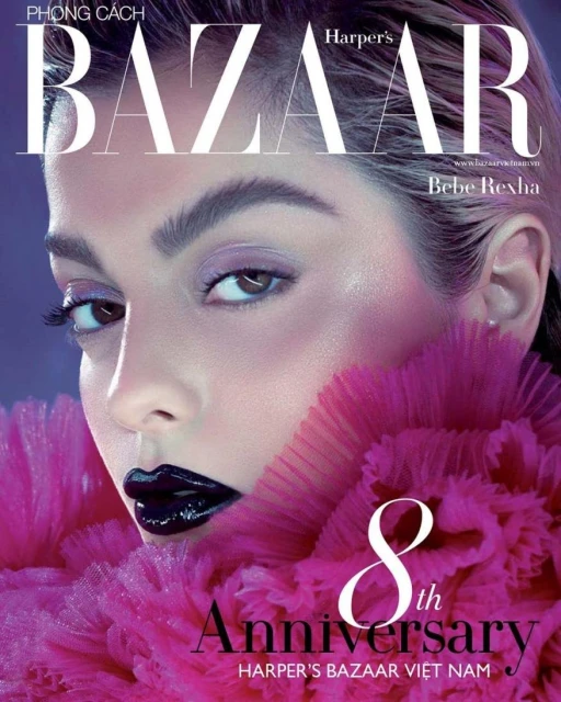 Harper's Bazaar Vietnam cover featuring Bebe Rexha with bold makeup, a pink ruffled collar, and magazine text, celebrating the 8th anniversary.