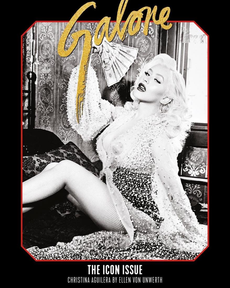 Christina Aguilera in a magazine cover, reclining and holding money. Gold Galore text overlay, ornate vintage background with red frame.