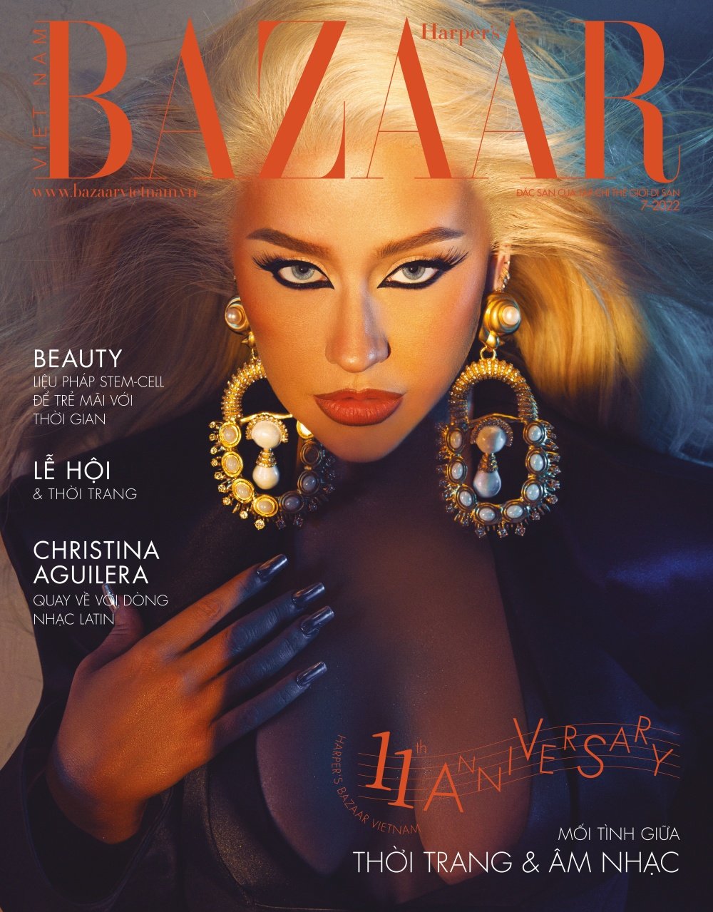 Magazine cover featuring a striking portrait of Christina Aguilera with platinum hair, large earrings, and bold makeup in a close-up shot.