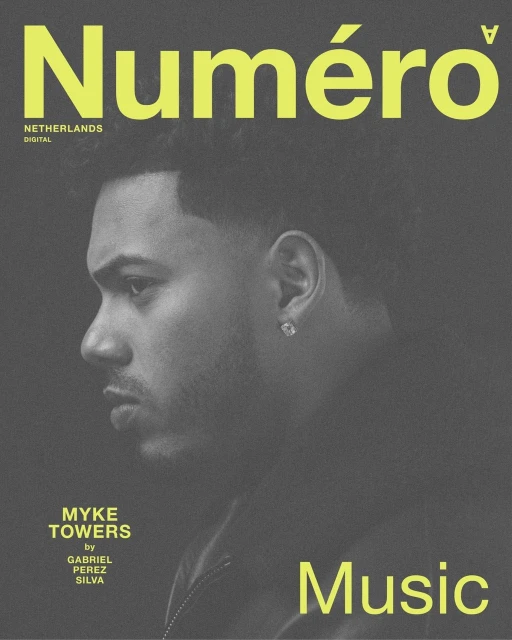 Magazine cover featuring Myke Towers in muted grey tones, with neon yellow branding and text. A monochromatic portrait.