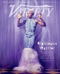 Cynthia Erivo wearing a denim gown with a feathered hem against a purple tulle background for a magazine cover