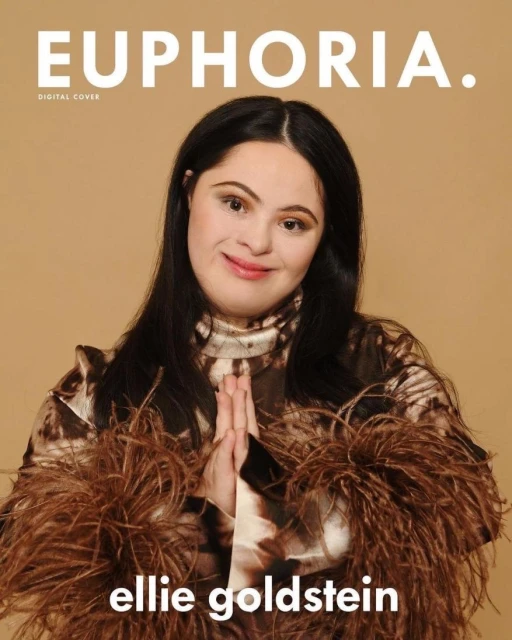 Euphoria magazine cover featuring Ellie Goldstein, a woman with Down syndrome, posing in a brown feathery top against a tan backdrop.