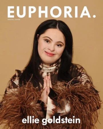 Euphoria magazine cover featuring Ellie Goldstein, a woman with Down syndrome, posing in a brown feathery top against a tan backdrop.