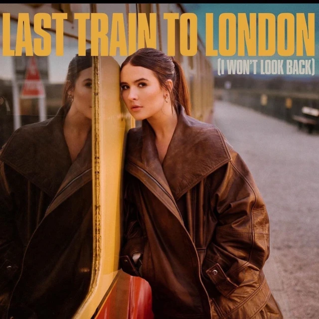 Portrait of a woman in a brown leather coat leaning against a train car with 'Last Train to London' displayed in yellow text.