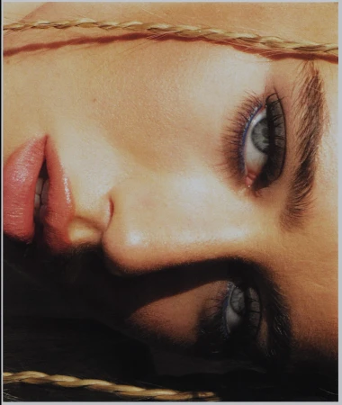 Close-up beauty portrait of a woman face with blue eyeliner and braided blonde hair by Jacinta Spencer