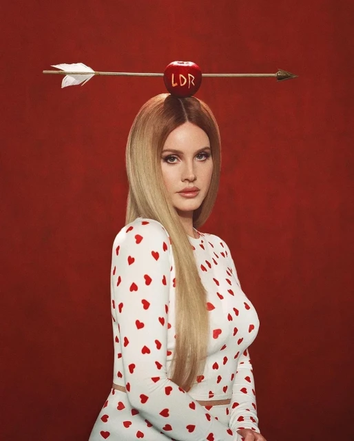 A portrait of a woman with an apple on her head pierced by an arrow, wearing a white dress with small red hearts, against a red background.