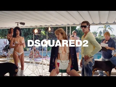 Outdoor fashion shoot featuring two women in swimwear and dresses, styled with pearls, and a man in sunglasses, set poolside with equipment.