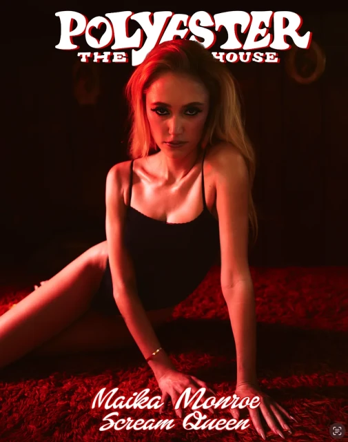 Magazine cover featuring a woman with long blonde hair in a black spaghetti strap top lying on a red textured surface.