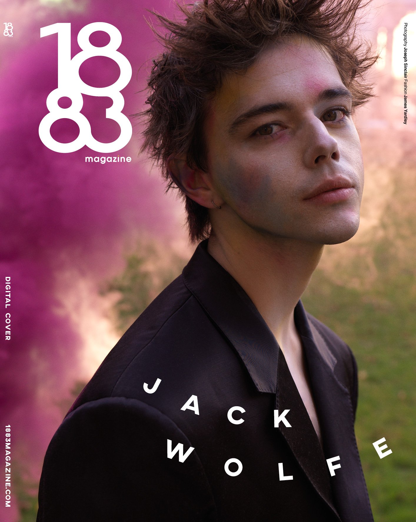 Magazine cover featuring Jack Wolfe in a dark suit with a soft-focus outdoor backdrop and magazine typography and logo.