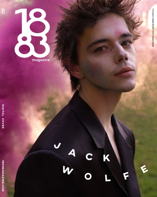 Magazine cover featuring Jack Wolfe in a dark suit with a soft-focus outdoor backdrop and magazine typography and logo.