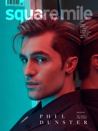 Magazine cover featuring a portrait of Phil Dunster, star of Ted Lasso, wearing a blazer in red and blue lighting with 'Square Mile' logo.