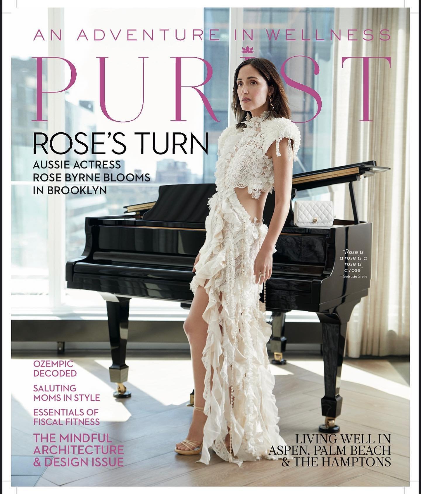 Magazine cover featuring Rose Byrne in a ruffled dress, alongside a piano and article titles, set against a city background.