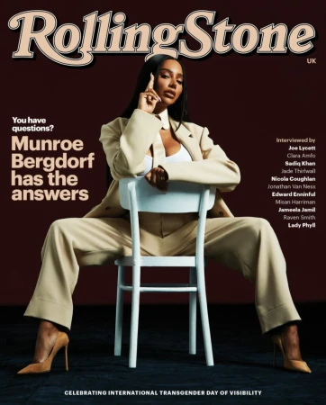 Magazine cover featuring Munroe Bergdorf in a beige suit, seated backward on a chair, Rolling Stone UK, celebrating International Transgender Day of Visibility.