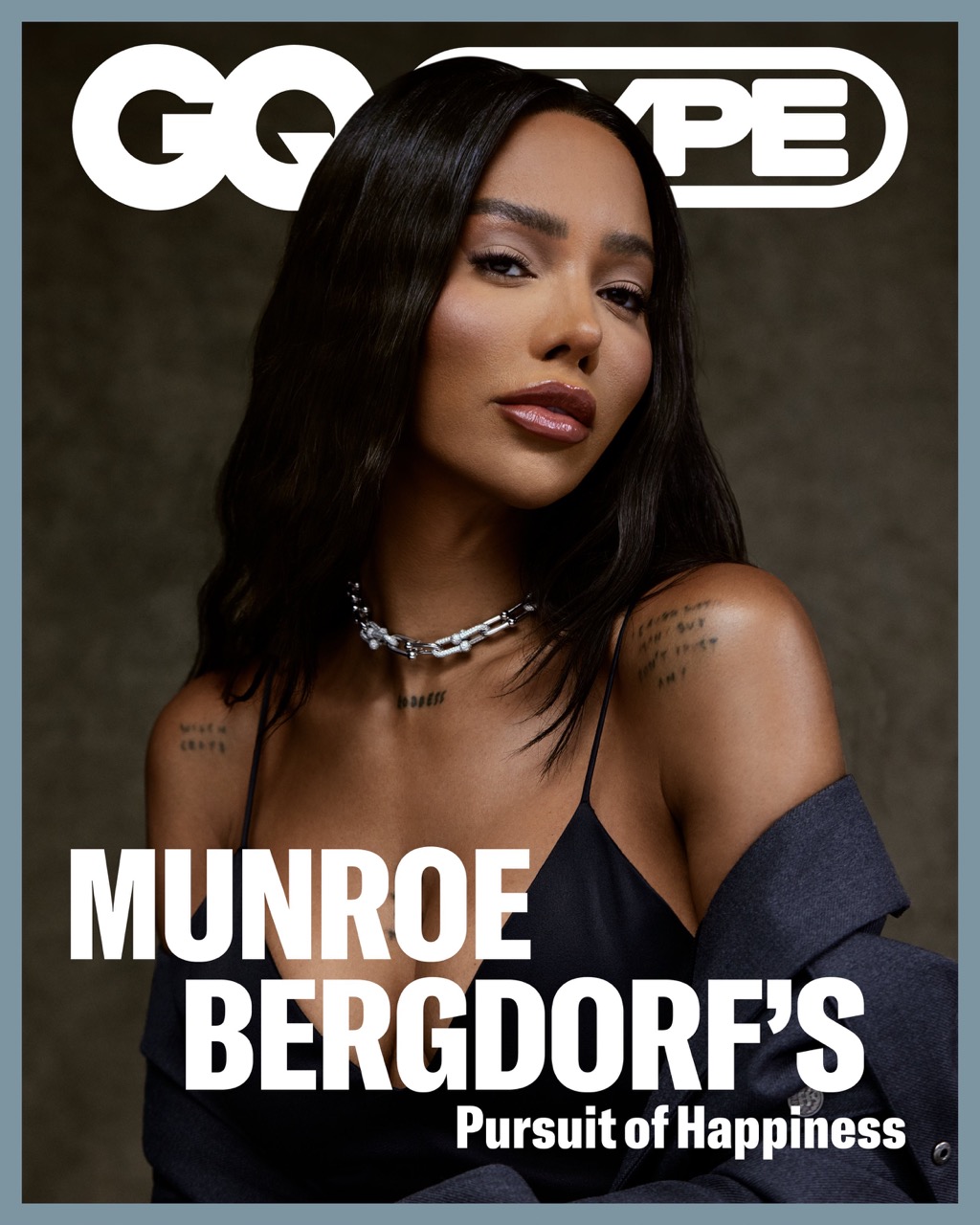 Magazine cover featuring a portrait of Munroe Bergdorf in a black top with a blazer, chain necklace, and gray background.