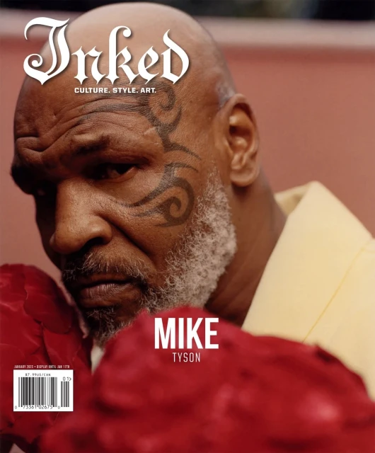 Magazine cover featuring a close-up of Mike Tyson, face tattooed, wearing a yellow shirt and red boxing gloves; the magazine's name is 'Inked'.