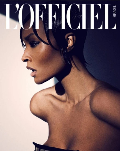 Magazine cover featuring a close-up profile of a Black female model with short dark hair, makeup, and bare shoulders against a gradient background.