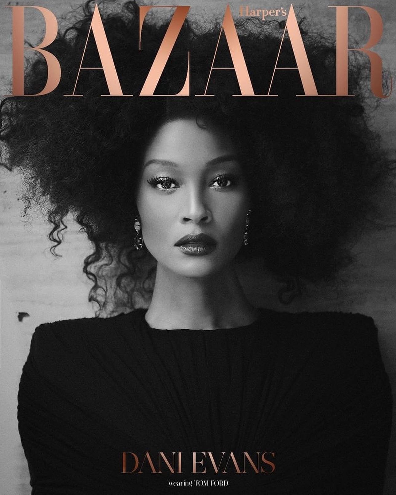 Black and white close-up portrait of Dani Evans on the cover of Harper's Bazaar, featuring her afro hairstyle, and Tom Ford fashion.