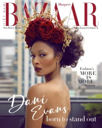 A woman wearing a crown of red roses and gold filigree, styled by Jazmin Kelly for Harper's Bazaar magazine cover.