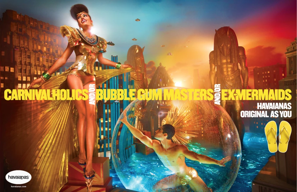 Fantasy-themed ad featuring a woman in golden attire and a man in a bubble, set against a cityscape and the Havaianas logo.