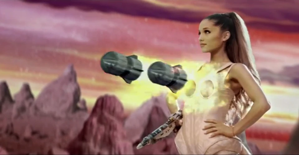 Ariana Grande in a futuristic setting with floating metallic objects, set against a stylized pink and orange sky and rocky landscape.