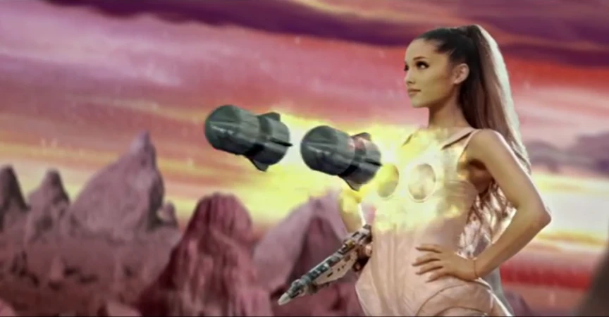 Ariana Grande in a futuristic setting with floating metallic objects, set against a stylized pink and orange sky and rocky landscape.