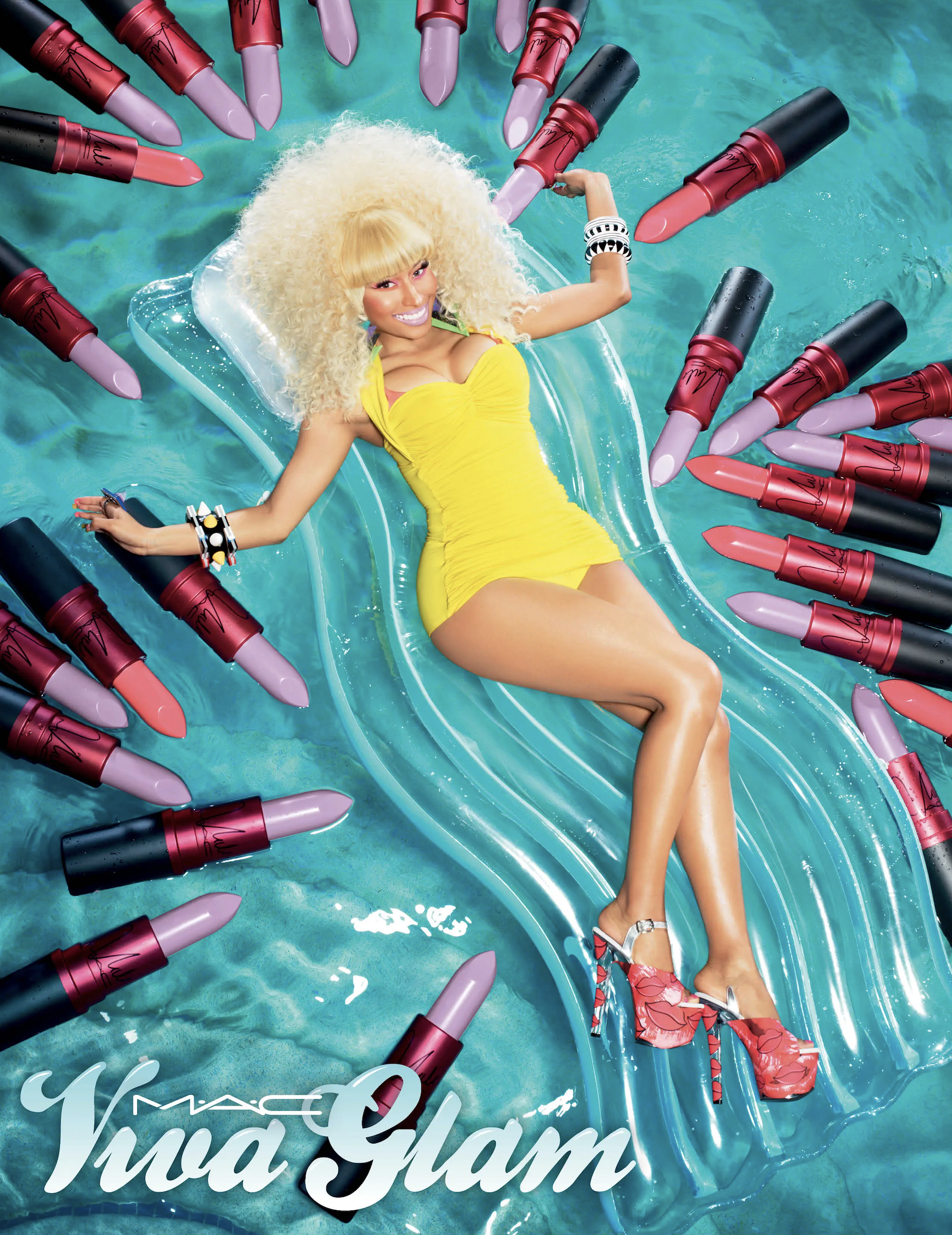 Woman in yellow swimsuit lying on inflatable raft surrounded by MAC Viva Glam lipsticks, promoting beauty and cosmetics.