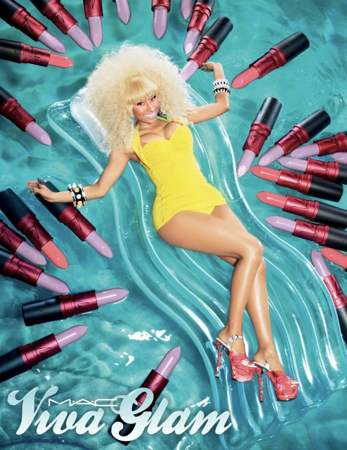 Woman in yellow swimsuit lying on inflatable raft surrounded by MAC Viva Glam lipsticks, promoting beauty and cosmetics.