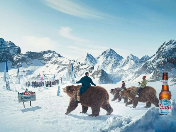 People riding brown bears in a snowy mountain landscape, Coors Mountain beer bottle in foreground, flags and crowd in background.