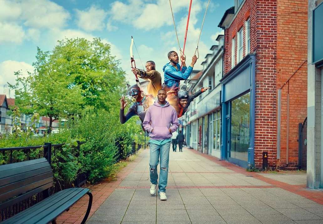 Digitally manipulated image of an African American man in casual wear walking on a sidewalk, above him are four versions of him.
