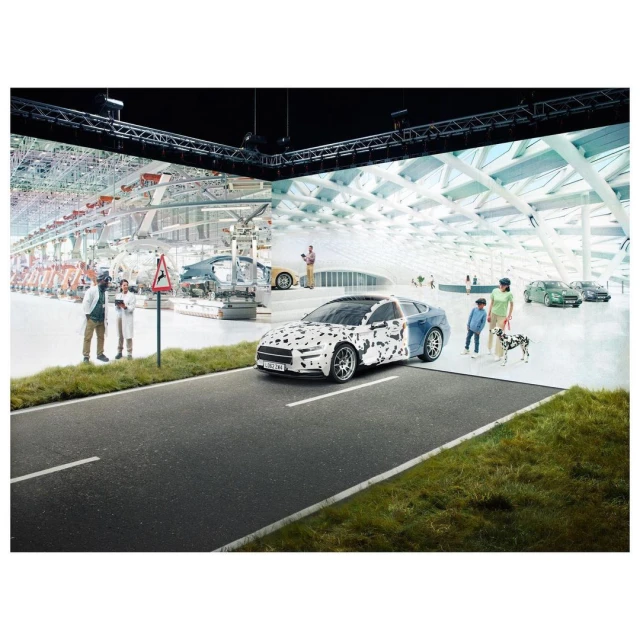Conceptual automotive image: partially masked car on road with engineers and family in background, showcasing vehicle development.
