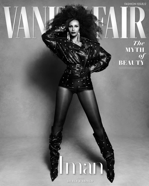 Vanity Fair cover featuring Iman in a studded black leather jacket, shorts, and slouch boots against a gray backdrop, fashion photography.